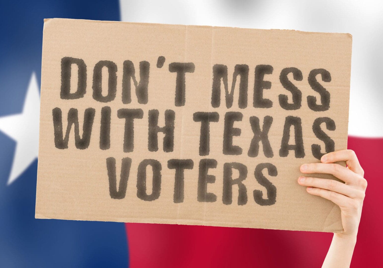 The phrase " Donât mess with Texas voters " on a banner in men's hand with blurred Texans flag on the background. Fraud. Laws. Voice. Survey. News. Nation. Duty. Citizen. Bulletin. System. Texan