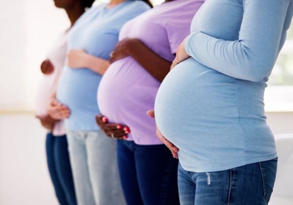 Pregnant Woman Group In Row. Young Mothers